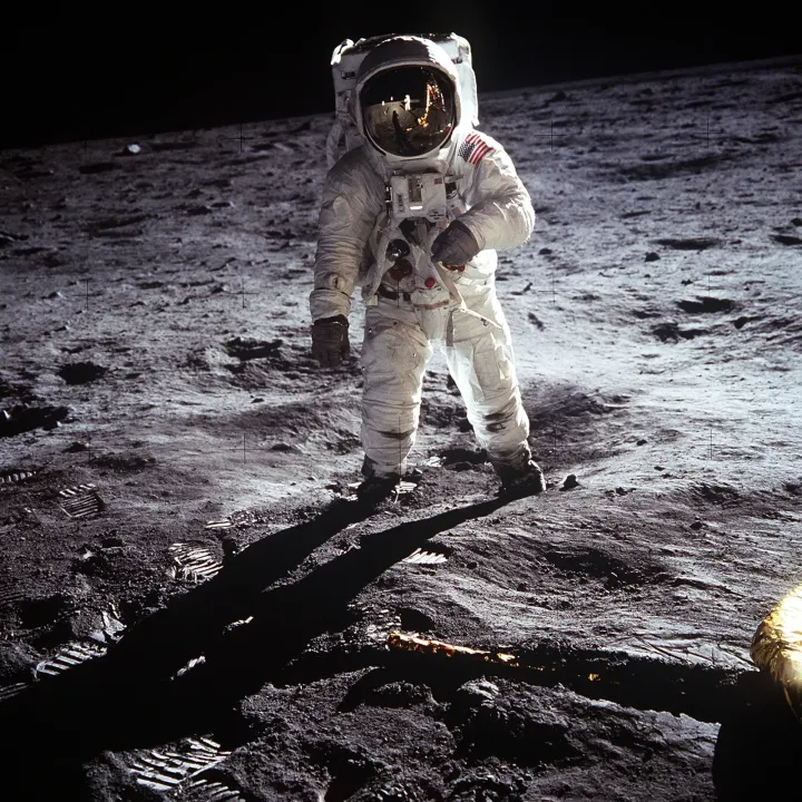 Buzz Aldrin standing beside the American flag on the lunar surface
