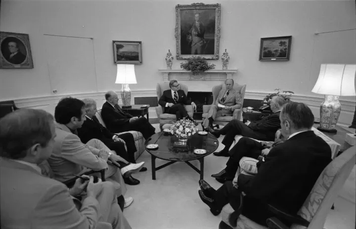 President Ford receiving the Rockefeller Commission report on CIA activities, 1975