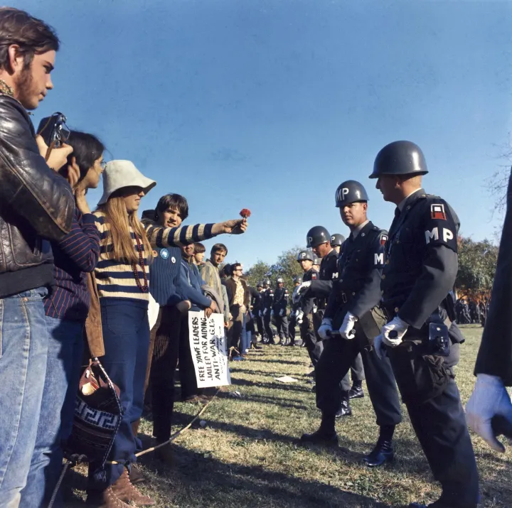 Anti-war demonstrator offers flower to military police at the Pentagon, 1967