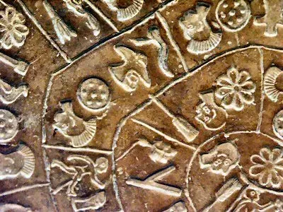 Close-up of stamped symbols on the Phaistos Disc