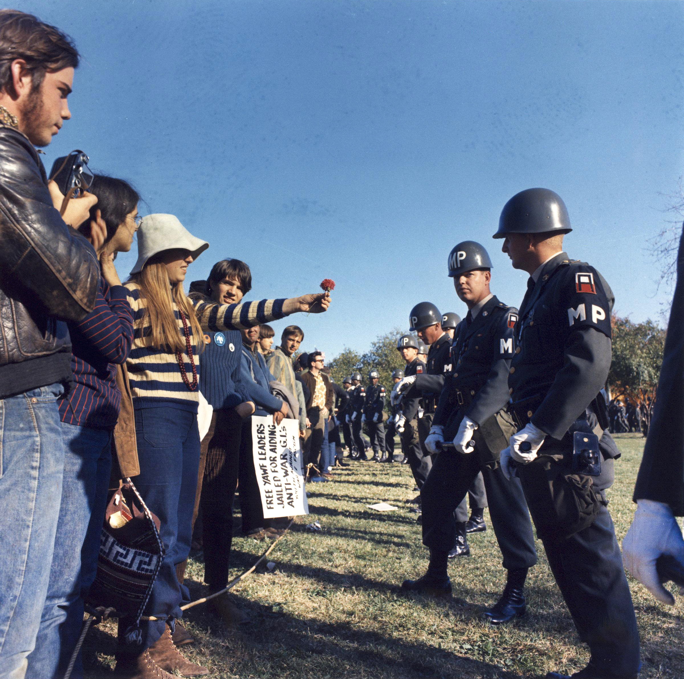 Anti-war demonstrator offers flower to military police at the Pentagon, 1967