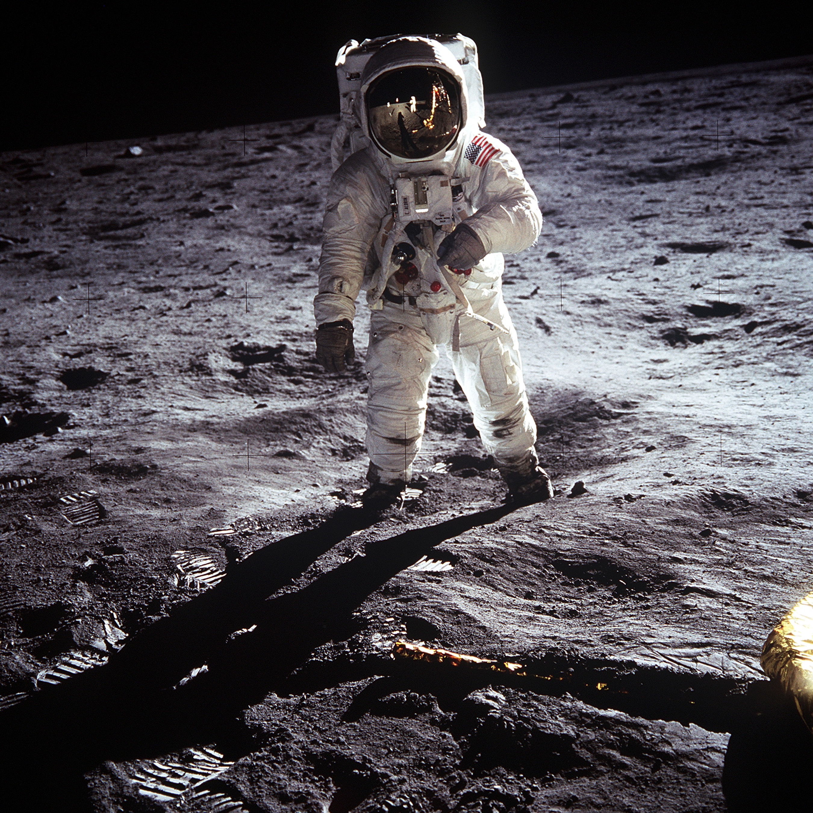 Buzz Aldrin standing beside the American flag on the lunar surface