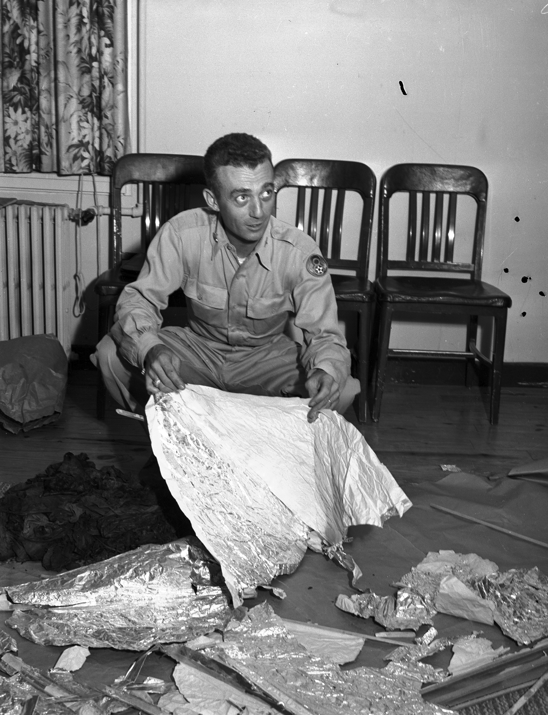 Major Jesse Marcel holding debris in General Ramey's office, July 8, 1947